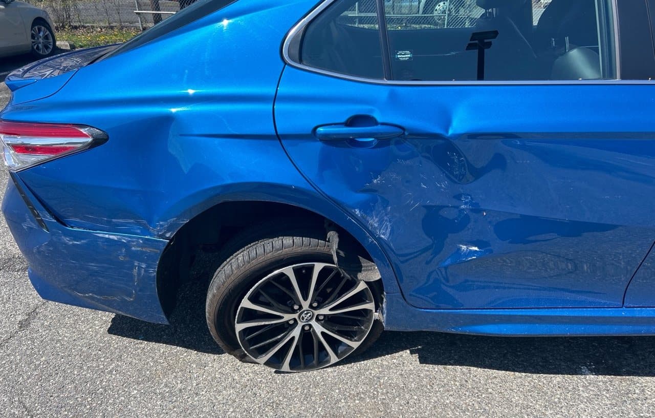 Damaged wheel and flat tire before roadside tire service