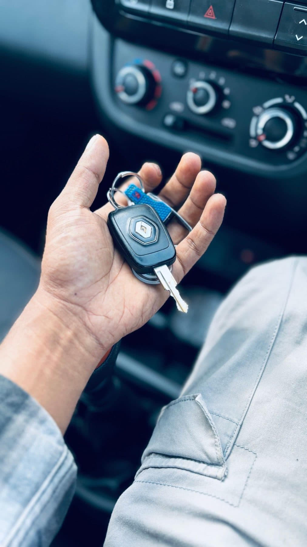 Driver holding car keys inside a vehicle before a lockout call