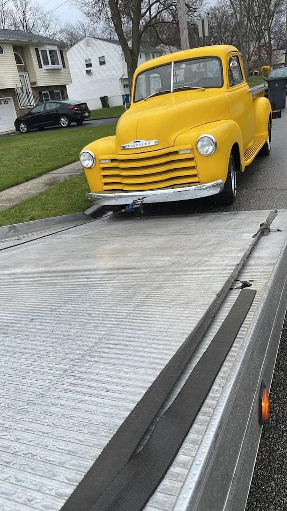 Classic vehicle being loaded for junk car removal service